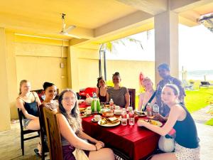 a group of people sitting around a table at Ayomal Beach Paradise in Galle