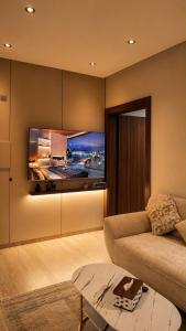 a living room with a couch and a flat screen tv at Advantage Residence in Medina