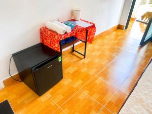 a room with a table and a table with a stool at Khách sạn Thu Hòn Rơm Phan Thiết in Phan Thiet