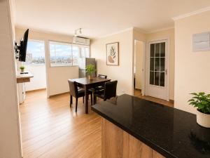 a kitchen and dining room with a table and chairs at Hotel Asia Pacifico in Santiago +31 photos