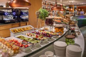 a buffet with fruits and vegetables on a table at Meliá Barcelona Sarrià in Barcelona +60 photos