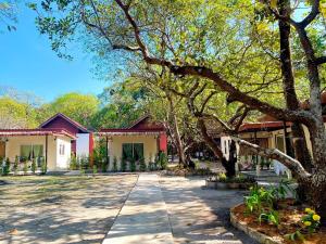 a courtyard of a house with a tree at Lucky Resort in Ko Phayam