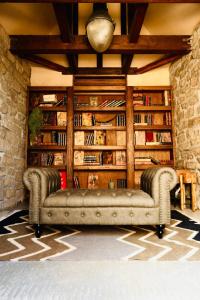 a couch in a room with a book shelf at WAAP Hotel in Ishigaki Island