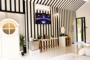 a bedroom with a black and white striped wall at S-Cape at Rim Khwae in Ban Tha Thong Mon
