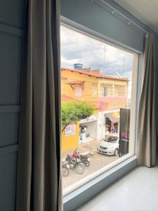 a window with a view of a street at Hospedaria Terra da Opala in Pedro II