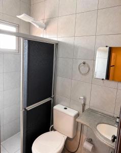 a small bathroom with a toilet and a sink at Hospedaria Terra da Opala in Pedro II