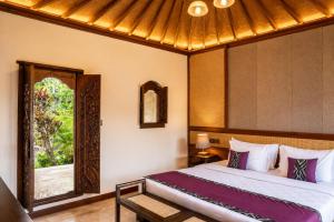 a bedroom with a large bed and a window at Mumbul Ubud in Ubud +58 photos