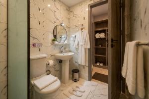 a bathroom with a toilet and a sink at Golden RZ pyramids view in Cairo +57 photos