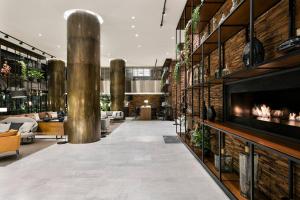 a lobby with a fireplace in a building at Meliá Madrid Princesa in Madrid +81 photos