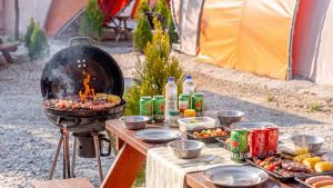 a grill with a bunch of food on a table at Muju Land Camping Glamping in Muju