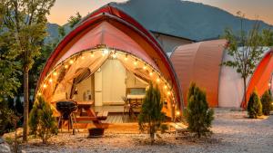 an exterior view of a tent with a table and a grill at Muju Land Camping Glamping in Muju