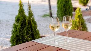 two glasses of white wine sitting on a table at Muju Land Camping Glamping in Muju