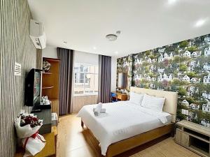 a hotel room with a bed and a tv at AILEN BOUTIQUE HOTEL in Ho Chi Minh City