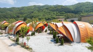a bunch of tents are lined up in the sand at Muju Land Camping Glamping in Muju +2 photos
