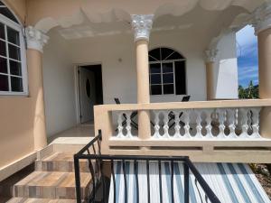 a balcony of a house with a staircase at Serenity Escape in Runaway Bay