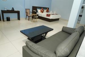 a living room with a couch and a bed at MRM Grand Park in Pudukkottai