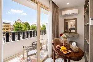 a room with a table with fruit on a balcony at Golden RZ pyramids view in Cairo