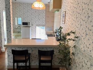 a kitchen with two chairs and a counter in a room at 伊豆ビーチクラブ in Shimoda +21 photos