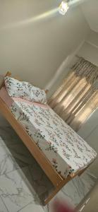 a bed with flowers on it in a room at Hidden Gem in Happy Hill