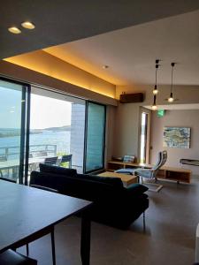 a living room with a couch and chairs in a building at Ciel Bleu in Yamaguchi