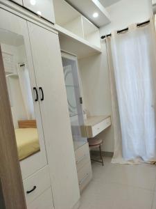 a small bedroom with a bed and a mirror at VP luxury moa staycation in Manila +7 photos