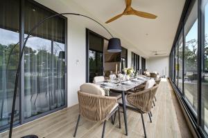 a dining room with a table and chairs at Seashore Beach Residences by NLA in Bang Tao Beach
