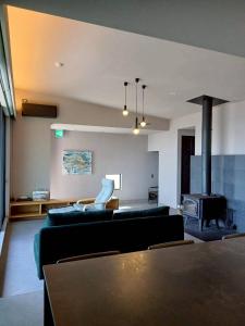 a living room with a couch and a fireplace at Ciel Bleu in Yamaguchi