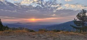 a sunset in the mountains with the sun setting at Yourte in Saint-Germain-de-Calberte