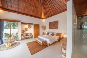 a bedroom with a bed and a living room at Dewi Kunti Villa in Tegalalang +64 photos