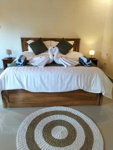 a bedroom with a large bed with towels on it at Japa Amerta Villa in Amed
