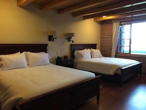 a bedroom with two beds and a window at Puertolago Country Inn & Resort in Otavalo +33 photos