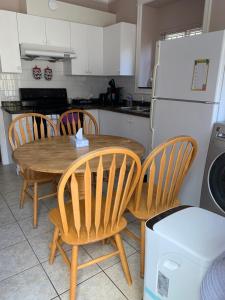 a kitchen with a table and chairs and a refrigerator at Vacation Home in Vancouver