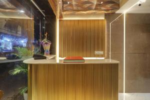 a bathroom with a counter with a book on it at Hotel Omega in Mumbai