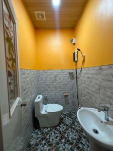 a bathroom with a sink and a toilet at SunriseStay in Panglao Island