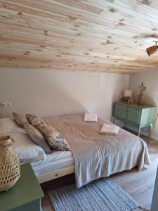 a bedroom with a bed and a wooden ceiling at Nadmorska Przystań in Gdańsk