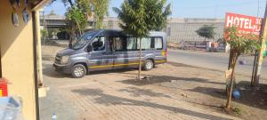 a small van parked on the side of a street at Hotel soni plaza in Jhālrapātan