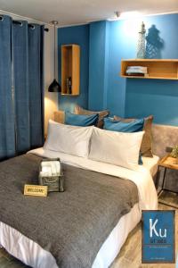 a bedroom with a large bed with blue walls at Ku at sea in Ko Samed