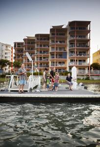 people on a boat in the water at On The River Apartments in Maroochydore