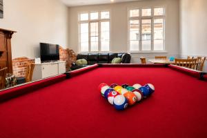 a living room with a red pool table at Geraldton Shoreline Lodge in Geraldton