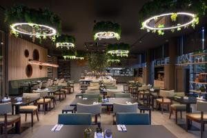 a restaurant with tables and chairs and lights at Meliá Braga Hotel & Spa in Braga