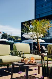 a patio with chairs and a table with food on it at Meliá Braga Hotel & Spa in Braga