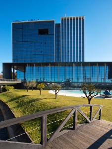 a large glass building with trees in front of it at Meliá Braga Hotel & Spa in Braga