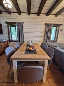 a living room with a wooden table and chairs at Lukstas Rest Park in Graužai