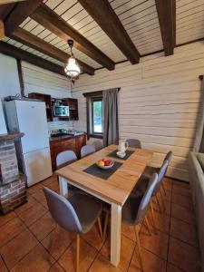 a kitchen and dining room with a wooden table and chairs at Lukstas Rest Park in Graužai +39 photos