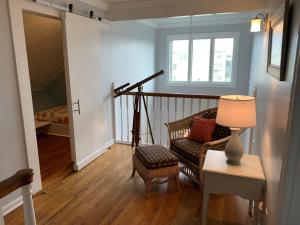 a living room with a couch and a table with a lamp at Tortuga home in Holden Beach
