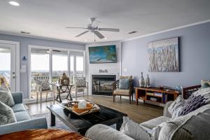 a living room with a couch and a fireplace at Ohana in Holden Beach