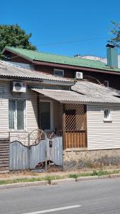 a house with a fence in front of it at ARTAPARTMENTS-center in Chernihiv
