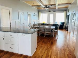 a kitchen and dining room with a table and chairs at Holden R Breath in Holden Beach