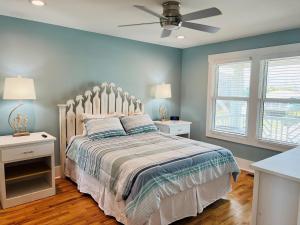 a bedroom with a bed and a ceiling fan at Holden R Breath in Holden Beach