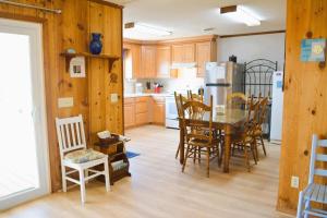 a kitchen and dining room with a table and chairs at Do-Little Dock in Holden Beach